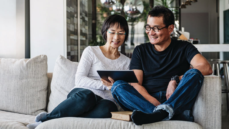 Couple on a couch using online banking